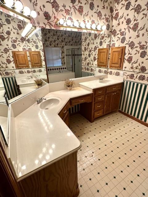 bathroom with vanity and a shower with door