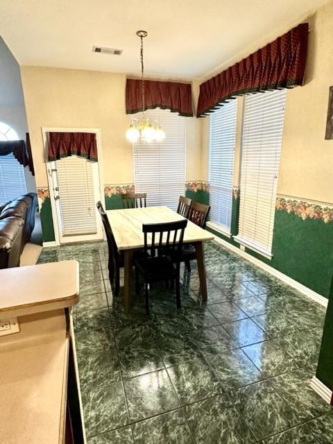 dining space featuring a notable chandelier