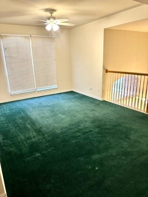 unfurnished room with ceiling fan and carpet floors