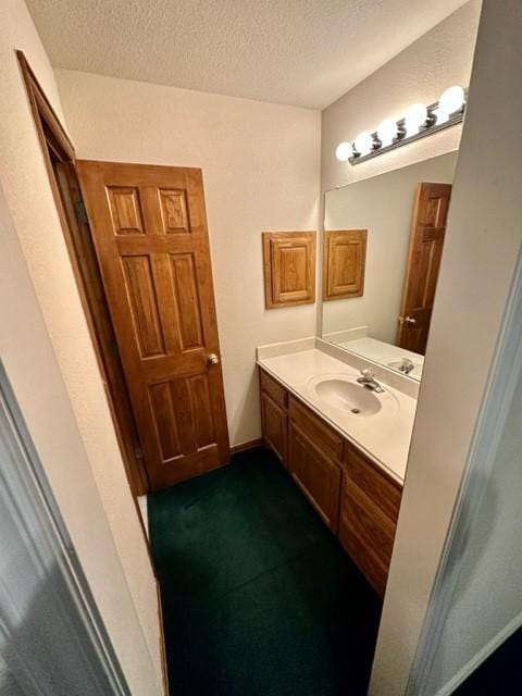 bathroom featuring vanity and a textured ceiling