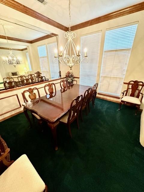 dining room featuring carpet flooring, a notable chandelier, and ornamental molding