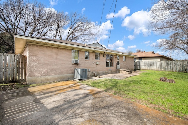 rear view of house with a patio area, a lawn, central AC, and cooling unit