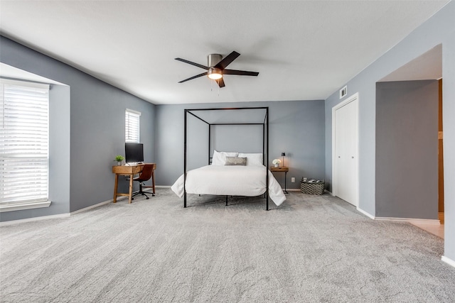 bedroom with ceiling fan and light colored carpet