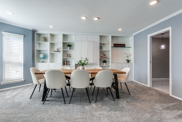 dining space with carpet floors and ornamental molding