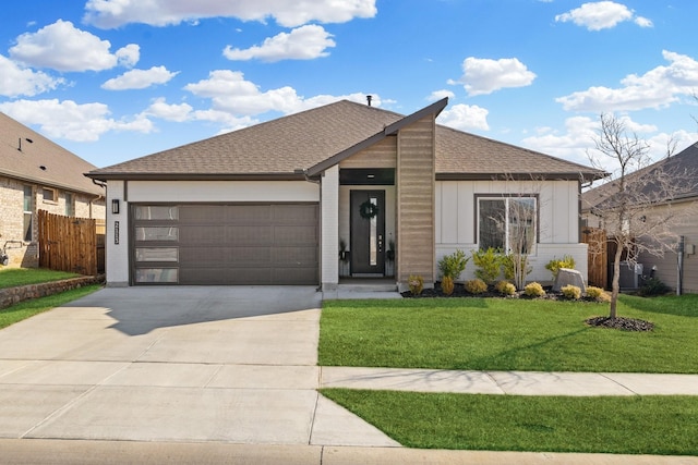 view of front of house featuring a front lawn and a garage