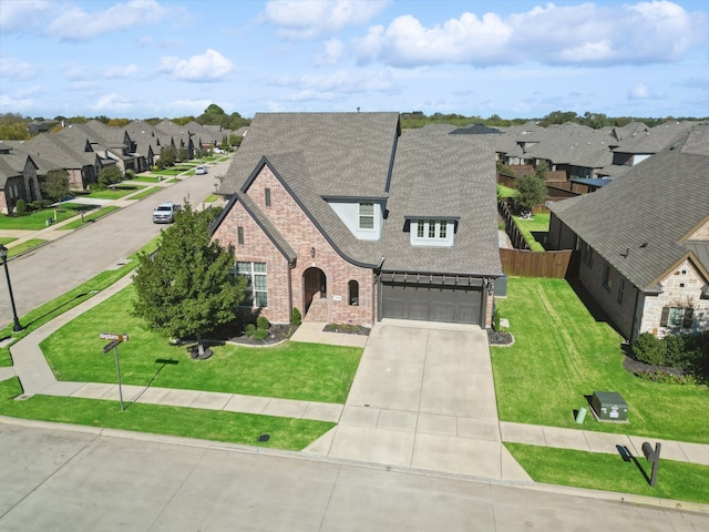 view of front of property with a front lawn and a garage