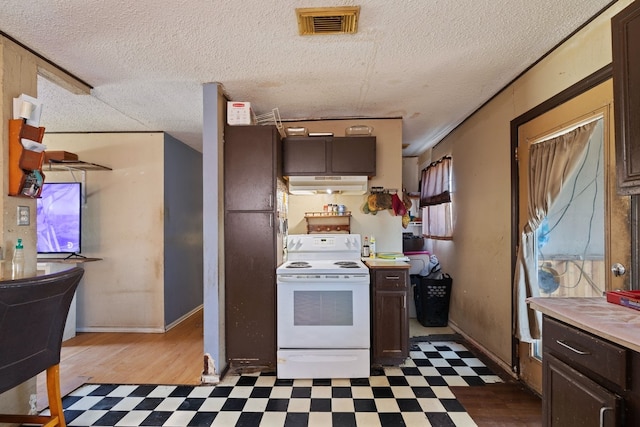 kitchen with dark brown cabinets, a textured ceiling, and white electric range