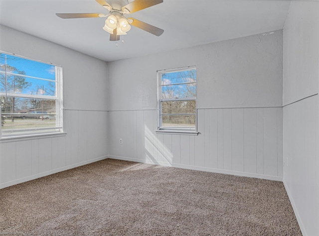 empty room featuring ceiling fan and carpet floors