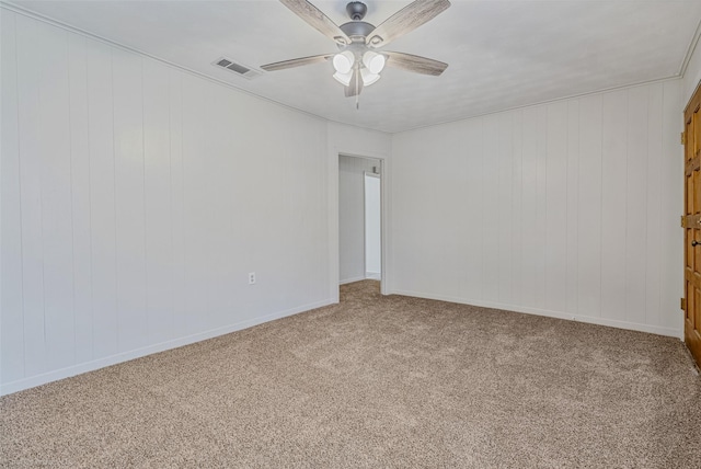 carpeted spare room featuring ceiling fan