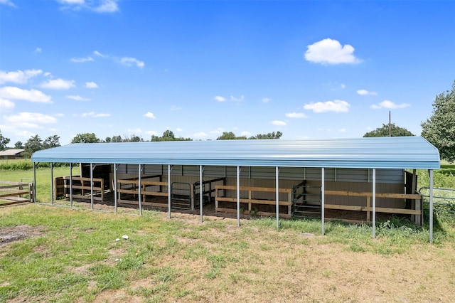 view of stable with a rural view