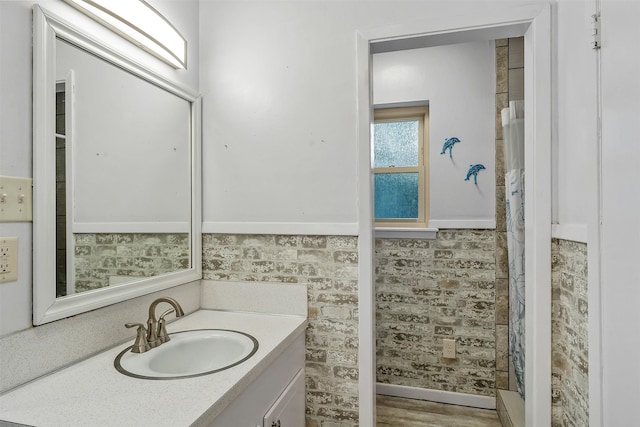 bathroom with hardwood / wood-style flooring and vanity