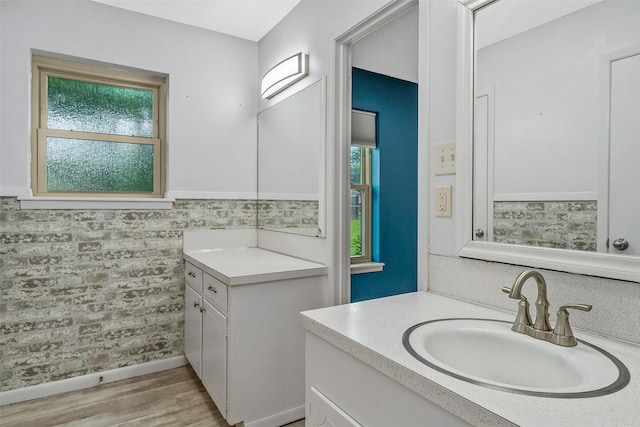 bathroom with hardwood / wood-style flooring, plenty of natural light, and vanity