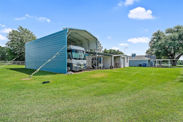 view of outbuilding featuring a yard and a carport