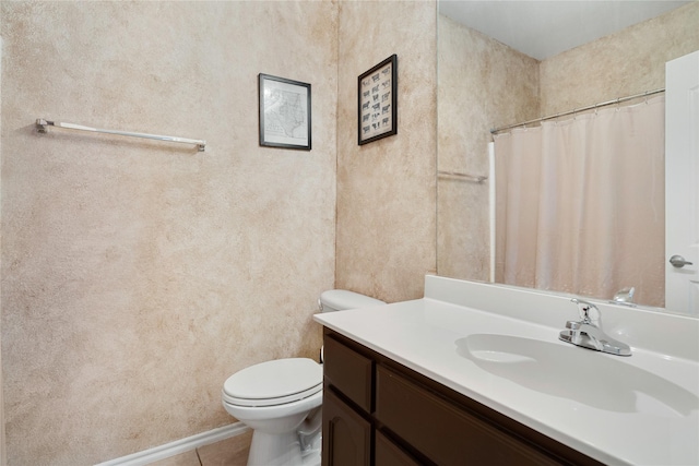 bathroom featuring vanity, tile patterned flooring, and toilet