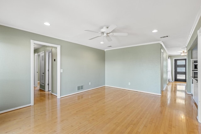 spare room with crown molding, ceiling fan, and light hardwood / wood-style flooring