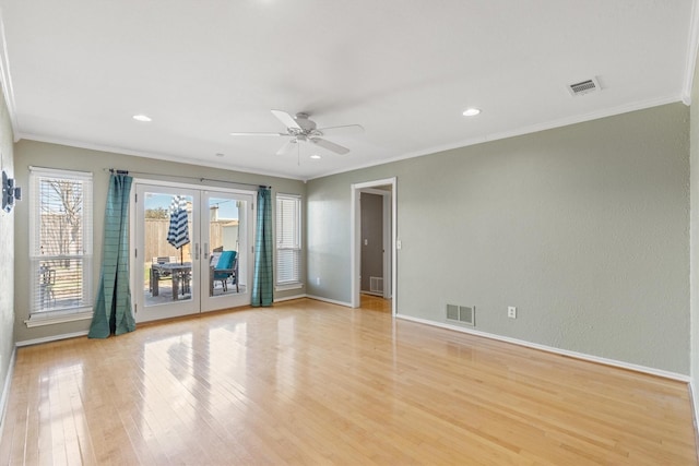 unfurnished room featuring ceiling fan, light hardwood / wood-style flooring, crown molding, and french doors