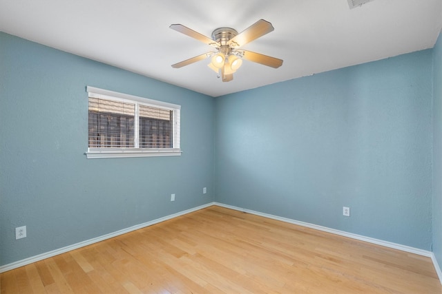 spare room with light hardwood / wood-style flooring and ceiling fan