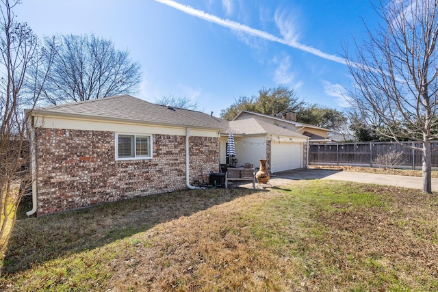 view of property exterior featuring a garage and a lawn