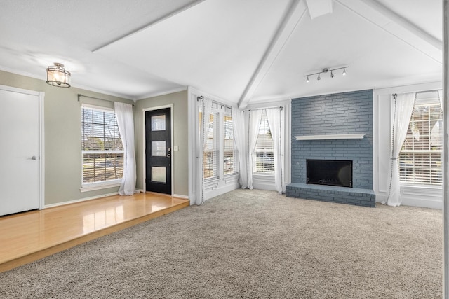 unfurnished living room with a fireplace, carpet flooring, and plenty of natural light