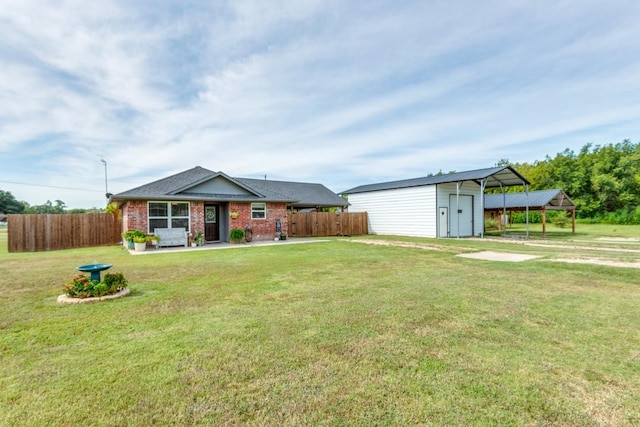 view of front of home with a front yard and a carport