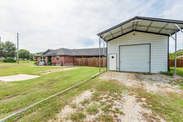 garage with a lawn and a carport