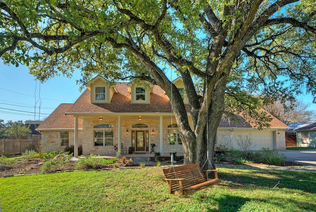 view of front of home with a front lawn, a porch, and a garage