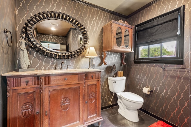 bathroom with toilet, vanity, tile patterned flooring, and crown molding