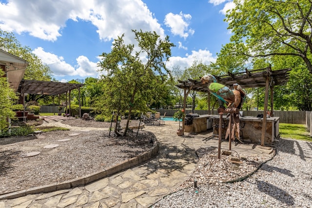 view of yard with a patio, a pergola, an outdoor bar, and a fenced in pool