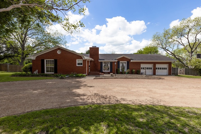 ranch-style home featuring a front lawn and a garage