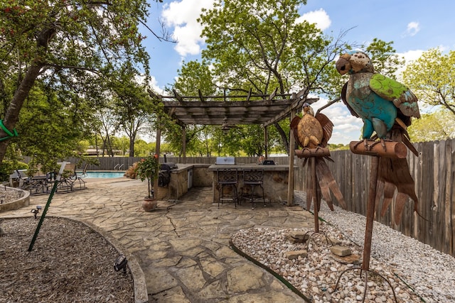 view of patio with a pergola, a fenced in pool, exterior kitchen, and a bar