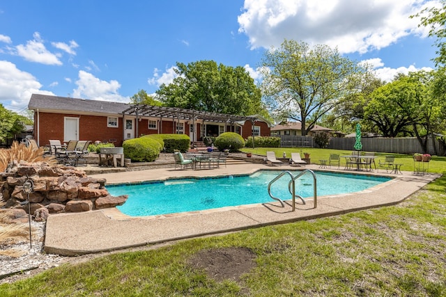 view of pool with a lawn and a patio