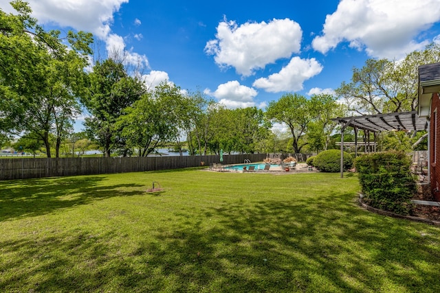 view of yard with a pergola and a fenced in pool