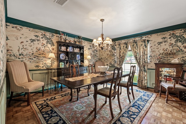 dining space with a chandelier, light parquet flooring, and ornamental molding