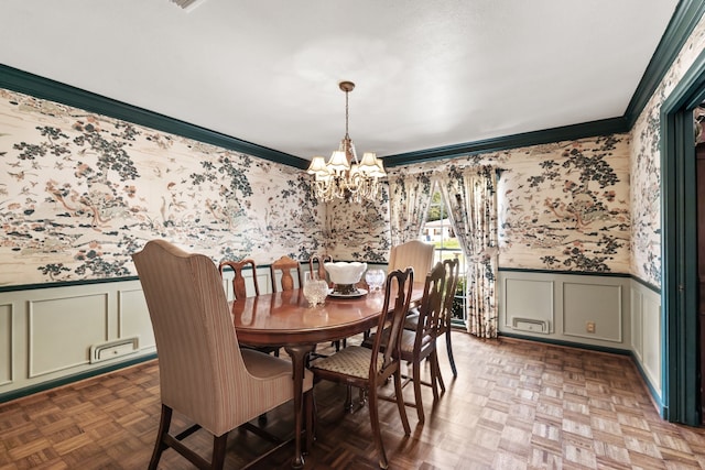 dining room with crown molding, parquet floors, and a notable chandelier