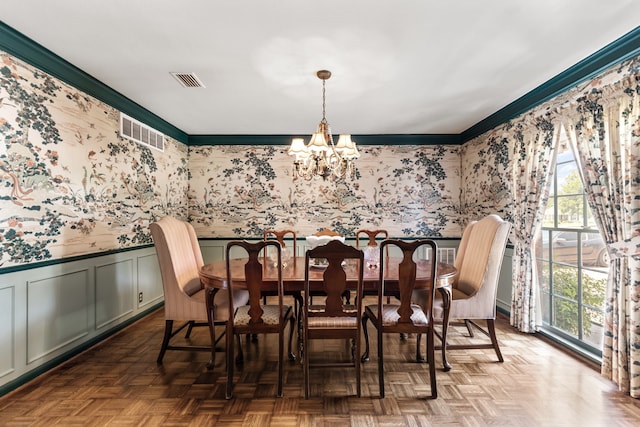 dining room with a chandelier, plenty of natural light, and dark parquet floors