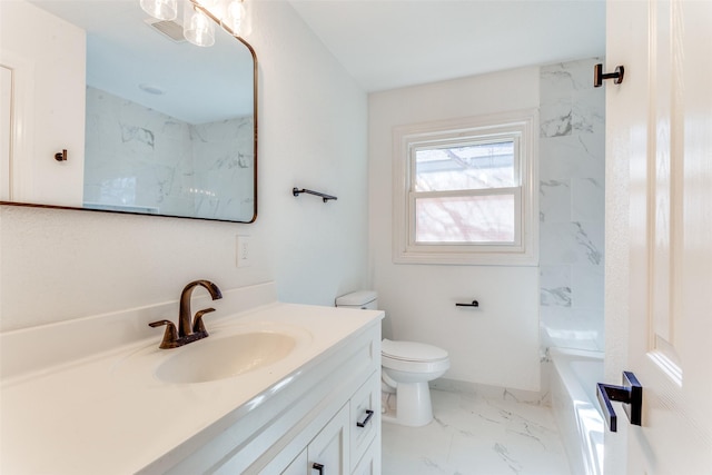 bathroom with toilet, vanity, and a bathtub