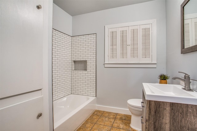 full bathroom featuring tile patterned floors, toilet, vanity, and tiled shower / bath combo