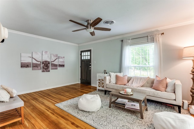 living room with crown molding, ceiling fan, and wood-type flooring