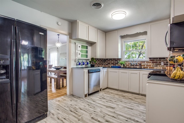 kitchen with white cabinets, light hardwood / wood-style floors, stainless steel appliances, and sink