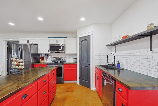 kitchen featuring wood counters, sink, white cabinetry, stainless steel appliances, and tasteful backsplash