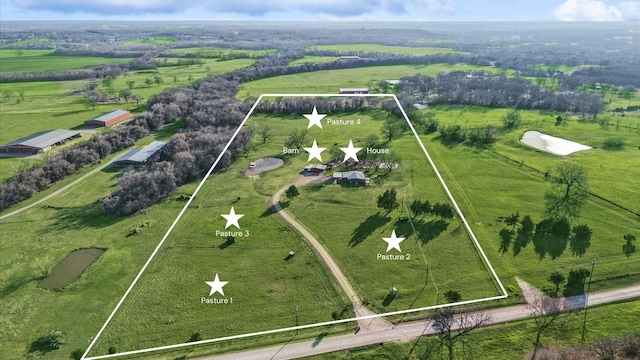 birds eye view of property featuring a rural view