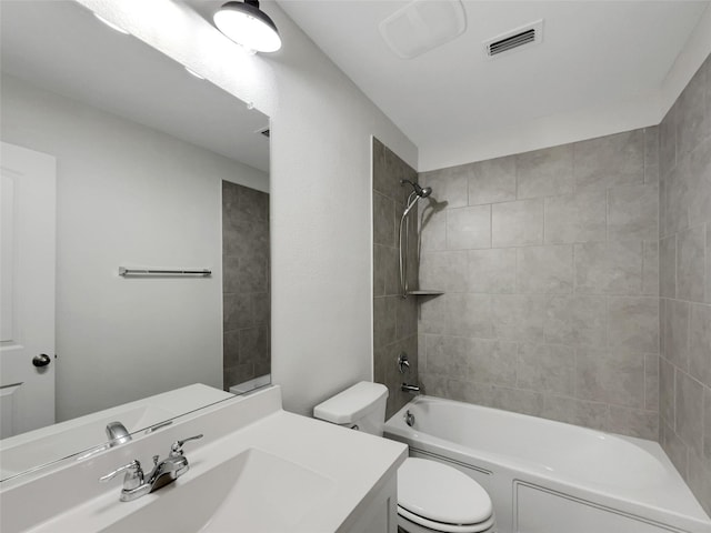 bathroom featuring toilet, bathtub / shower combination, visible vents, and vanity