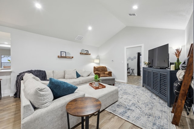 living area with vaulted ceiling, wood finished floors, visible vents, and recessed lighting