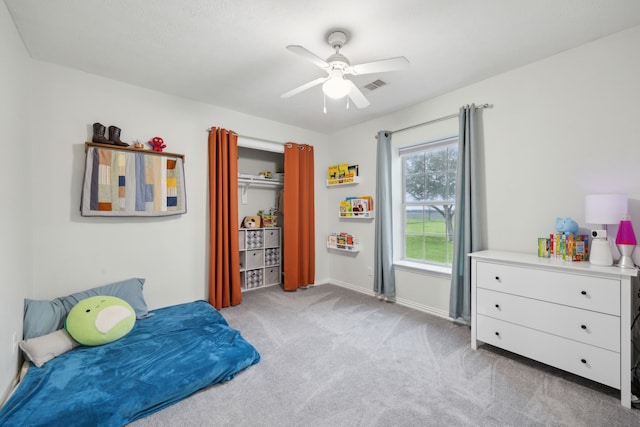 bedroom with a ceiling fan, visible vents, light carpet, and baseboards