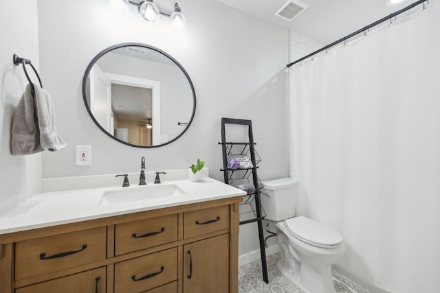 full bathroom featuring visible vents, vanity, and toilet