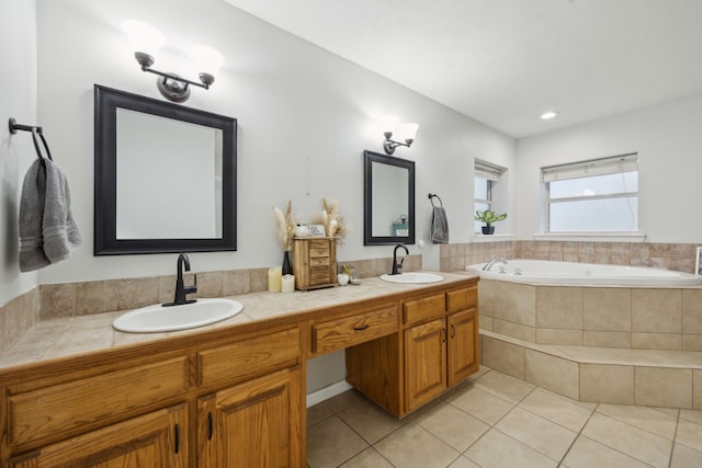 full bath with double vanity, a garden tub, a sink, and tile patterned floors