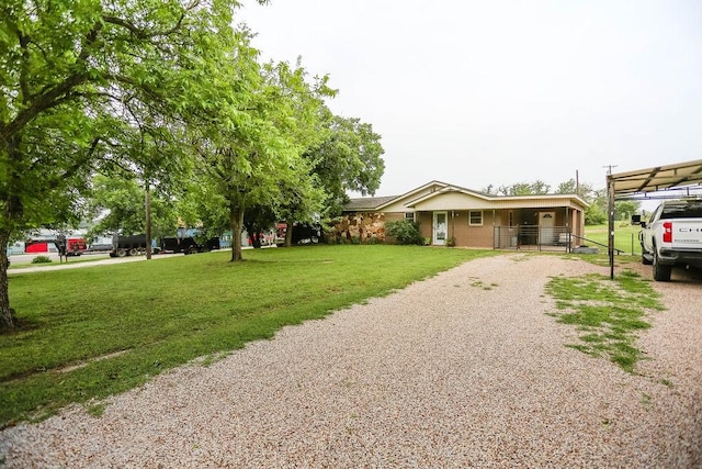 view of front of home with a carport and a front yard