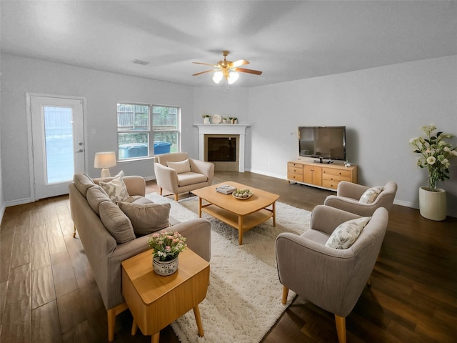 living room with ceiling fan and dark hardwood / wood-style floors