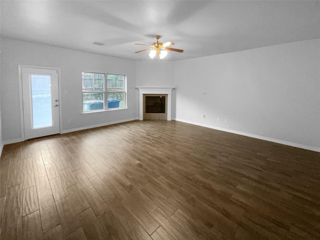 unfurnished living room with dark wood-type flooring and ceiling fan