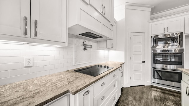 114 N Star Crossing Ln, Weatherford, TX 76088 - kitchen with light stone countertops, dark wood finished floors, white cabinetry, backsplash, and appliances with stainless steel finishes